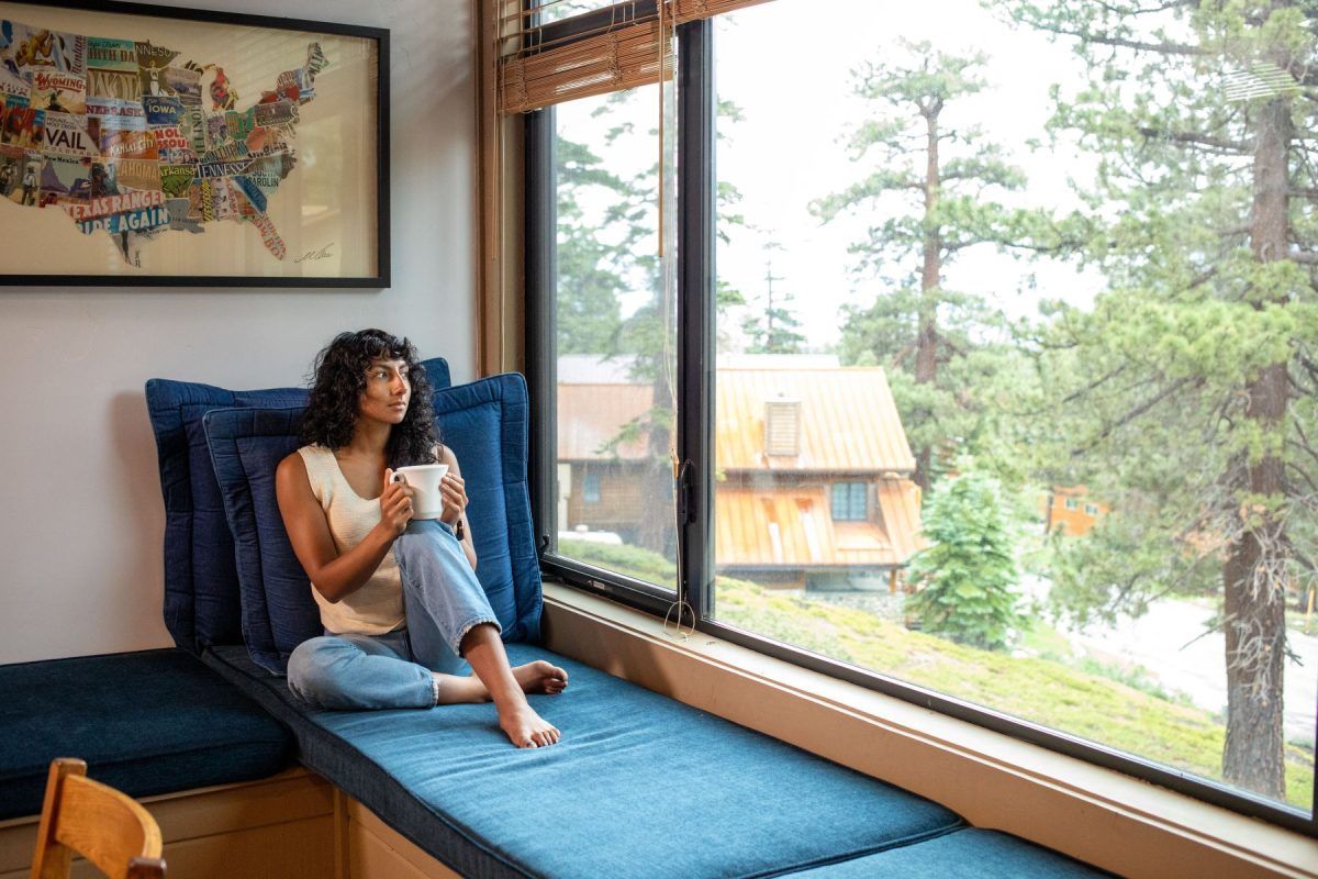 View of a person relaxing in Mammoth Lakes summer condo with 1849 Mountain Rentals